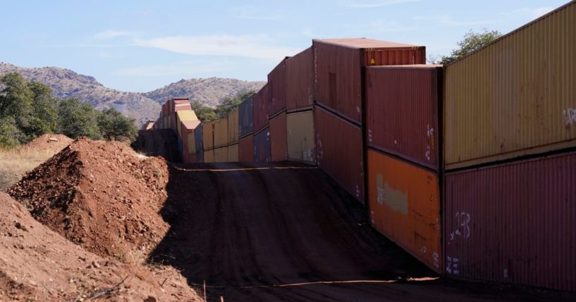 A long row of double-stacked shipping containers provides a new wall between the United States and Mexico in the remote section area of San Rafael Valley, Arizona.