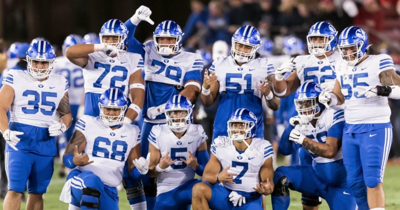 The BYU Cougars football team including Houston Heimuli #35, Sione Veikoso #72, Kingsley Suamataia #78, Alden Tofa #51, Joe Tukuafu #52, Lorenzo Fauatea #55, Peter Falaniko #68 and others pose for a group photo prior to an NCAA college football game against the Stanford Cardinal on November 26, 2022 at Stanford Stadium in Palo Alto, California.