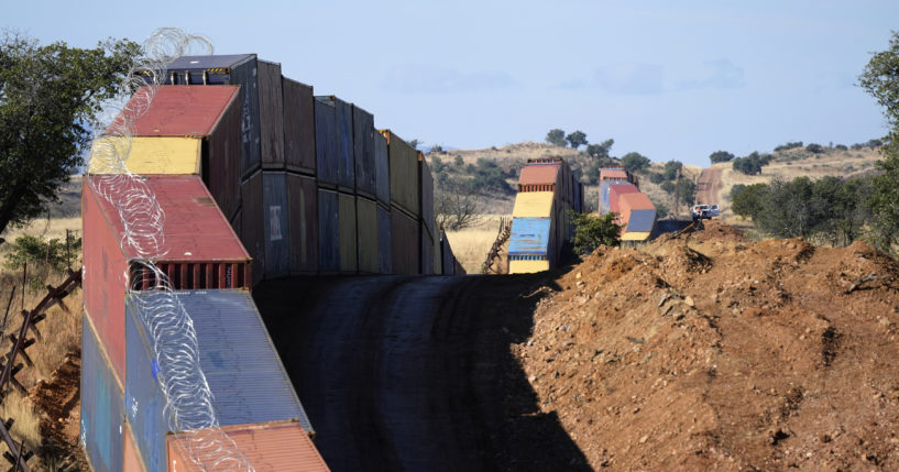 A long row of double-stacked shipping containers provide a new wall between the United States and Mexico in the remote section area of San Rafael Valley, Arizona, on Dec. 8.