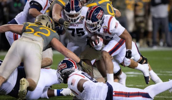 Anton Hall Jr. #34 of the Navy Midshipmen runs for no gain against the Army Black Knights at Lincoln Financial Field on Dec. 10 in Philadelphia.