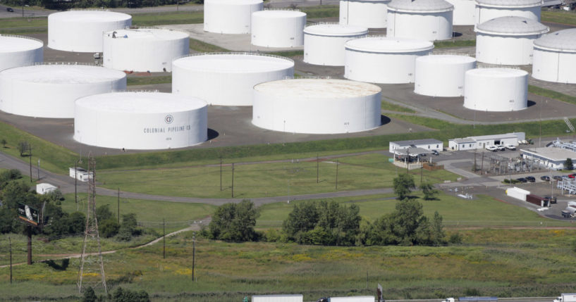 In this September 8, 2008 file photo traffic on I-95 passes oil storage tanks owned by the Colonial Pipeline Company in Linden, N.J.