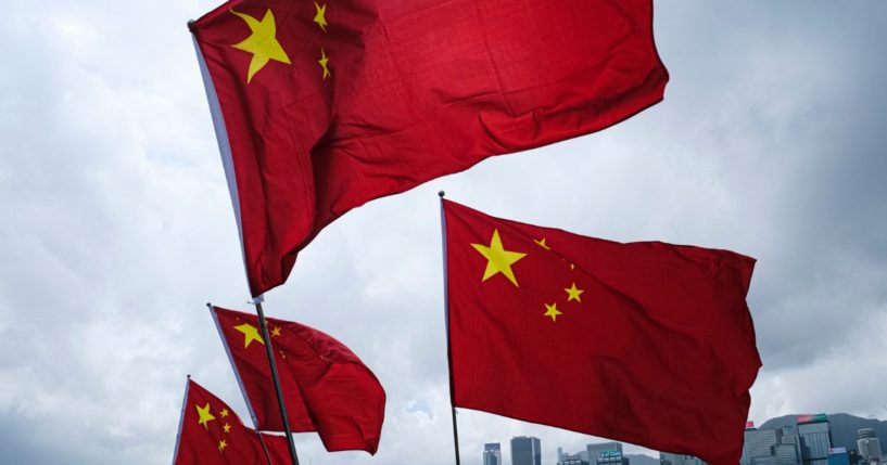 People wave Chinese flags on Oct. 1, 2022, in Hong Kong.