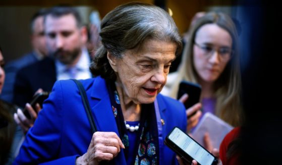 Democratic Sen. Dianne Feinstein of California is surrounded by reporters as she heads to the Senate Chamber for a vote at the U.S. Capitol in Washington on Tuesday.