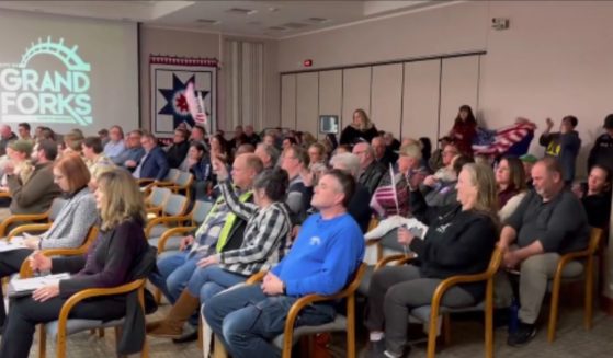 Residents cheer after the Grand Forks, North Dakota, City Council voted to shut down a Chinese corn mill project on Monday.