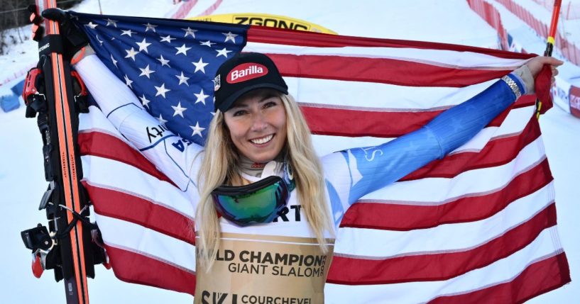 Mikaela Shiffrin celebrates with a U.S. flag after winning the women's giant slalom event of the FIS Alpine Ski World Championships in Meribel, French Alps, on Thursday.