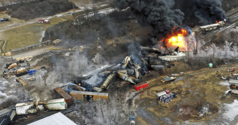 portions of a Norfolk and Southern freight train that derailed still burning