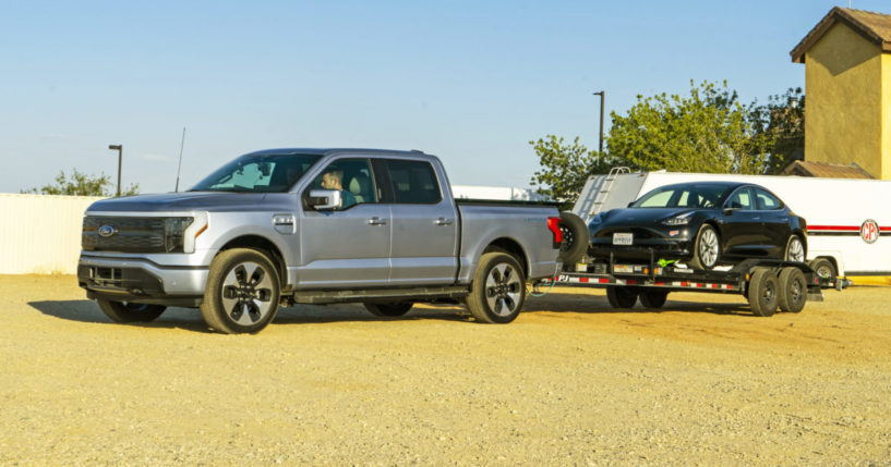 A pickup towing a car