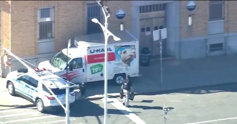 police inspecting a stopped U-Haul truck