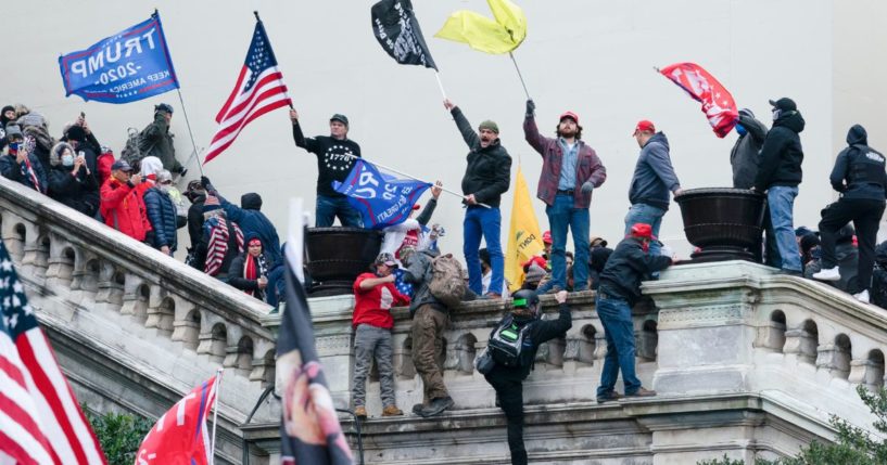 People waving flags on the West Front of the U.S. Capitol