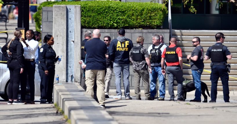 Members of the Louisville Metro Police and federal ATF agents gather outside of the Old National Bank building in Louisville on Monday.