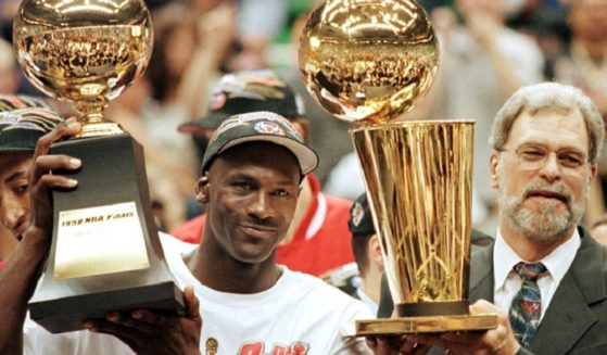 Former Chicago Bulls and Los Angeles Lakers coach Phil Jackson, right, poses in a 1998 file photo with Chicago Bulls great Michael Jordan after the Bulls won their sixth NBC championship.