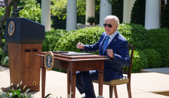 Joe Biden remarks that the desk is hot from the sun before signing an executive order that would create the White House Office of Environmental Justice, in the Rose Garden of the White House April 21, 2023 in Washington, DC.