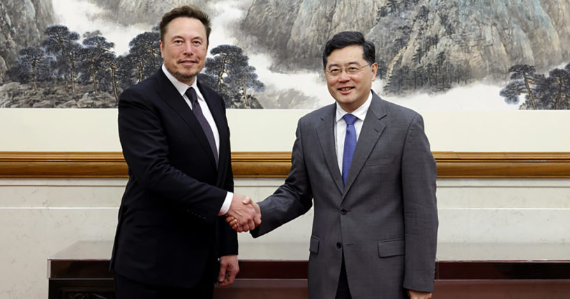 Chinese Foreign Minister Qin Gang, right, poses with Tesla CEO Elon Musk in Beijing on Tuesday.