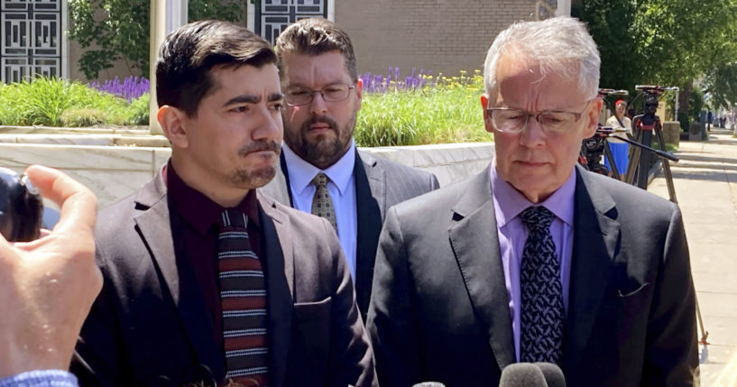 Michael DiMassa, left, and his lawyer, John Gulash, right, speak to reporters outside federal court in Hartford, Connecticut on Wednesday.