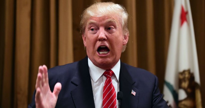 Donald Trump gestures at a press briefing where he introduced people whose families were victims of illegal immigrants on July 10, 2015, at the Beverly Wilshire Hotel in Beverly Hills, California.