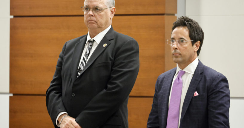 Former Marjory Stoneman Douglas High School School Resource Officer Scot Peterson, left, and defense attorney Mark Eiglarsh, right, stand as the jury enters the courtroom to be dismissed on Wednesday from Broward County Courthouse in Fort Lauderdale, Florida.