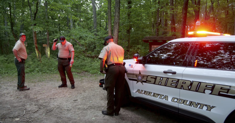 Authorities secure the entrance to Mine Bank Trail, an access point to the rescue operation along the Blue Ridge Parkway where a Cessna Citation crashed over mountainous terrain near Montebello, Virginia, Sunday.