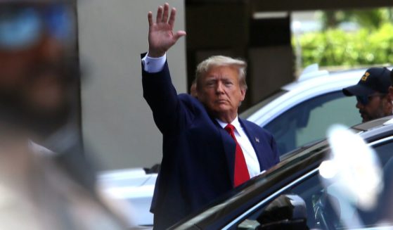 Former President Donald Trump waves after he appeared for his arraignment on Tuesday in Miami.