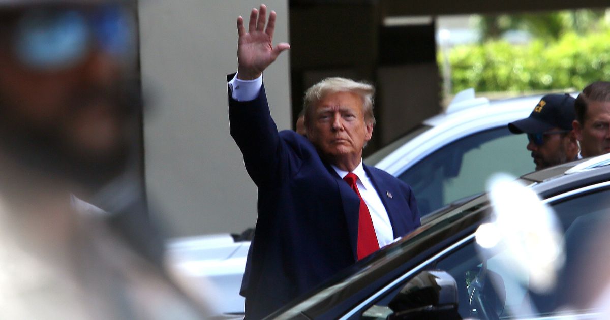 Former President Donald Trump waves after he appeared for his arraignment on Tuesday in Miami.