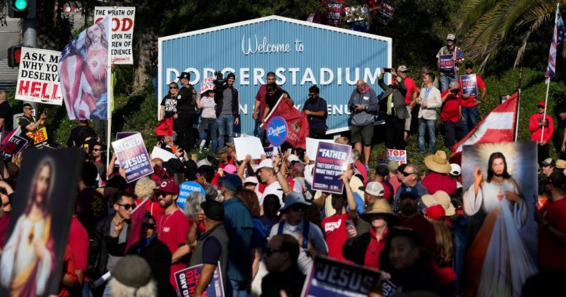 Protesters rally outside Dodger Stadium in Los Angeles after a prayer service Friday.