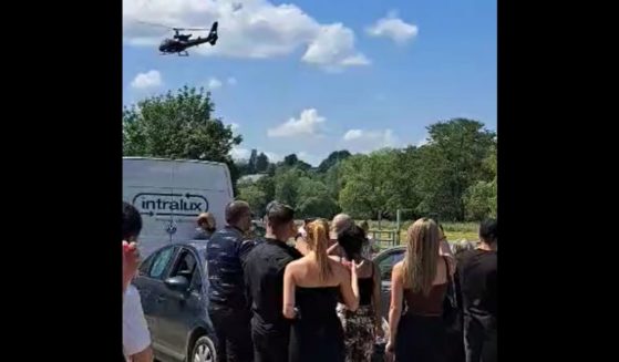 David Baerten of Liege, Belgium, arrives to his own funeral in a helicopter.