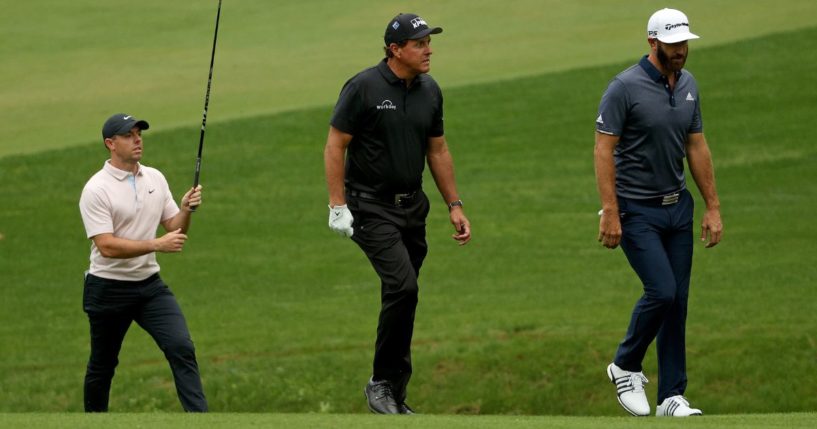 From left, golf stars Rory McIlroy, Phil Mickelson and Dustin Johnson walk during a practice round prior to the Masters at Augusta National Golf Club in Augusta, Georgia, on Nov. 10, 2020.