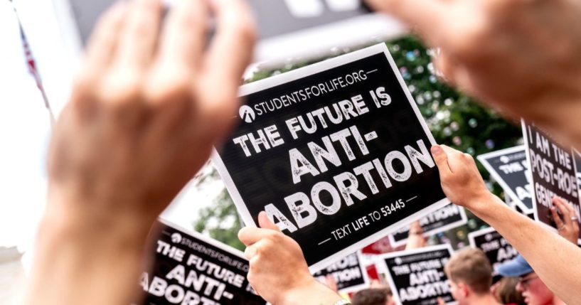 Pro-life activists hold signs outside the U.S. Supreme Court in Washington, D.C., on June 24, 2022.