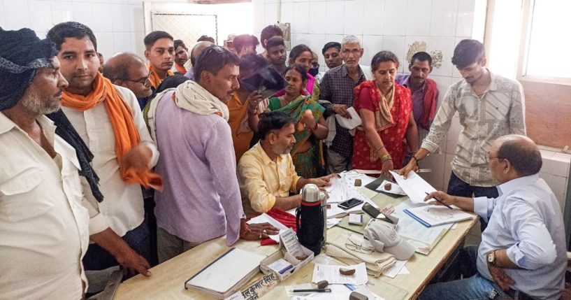 People crowd a hospital desk in Ballia district, in northern Uttar Pradesh state, India, on Sunday.