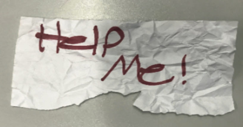 This undated photo shows a "help me" sign used by a 13-year-old girl kidnapped in Texas.