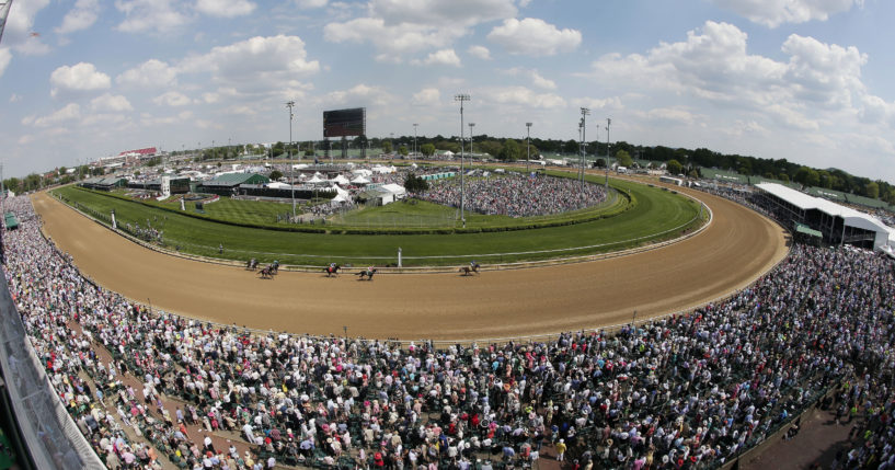 Fans watch a race before the 141st running of the Kentucky Derby horse race at Churchill Downs in Louisville, Kentucky, on May 2, 2015.