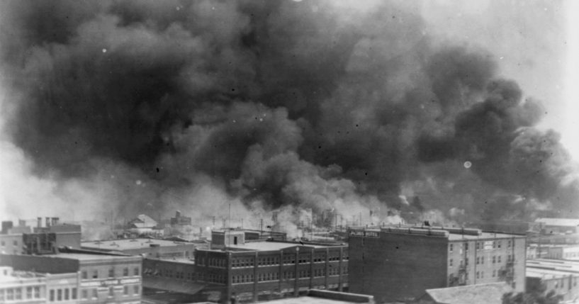 In this 1921 image, smoke billows over Tulsa, Oklahoma during the Tulsa Race Massacre.