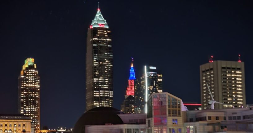 The downtown Cleveland, Ohio, skyline is lit up at night.