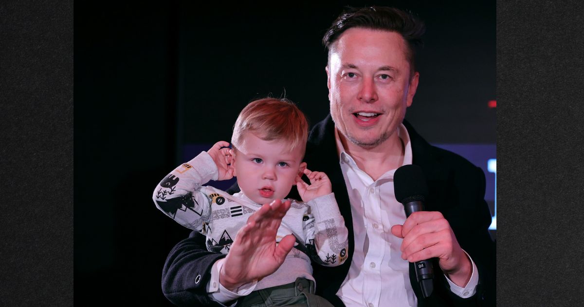 Elon Musk and son X Æ A-12 ("X" for short) are pictured in December 2021. Musk appeared to hint in a recent tweet that he would support voting rights being restricted to those with children