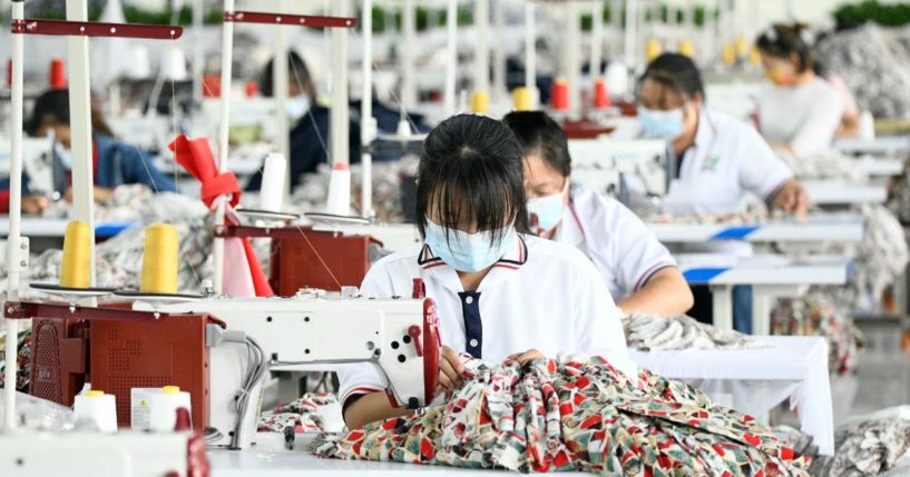 Employees work at a Chinese textile factory in an undated file photo. A new lawsuit charges that a Chinese company is violating copywright law by duplicating U.S. designs and selling the products back to Americans.