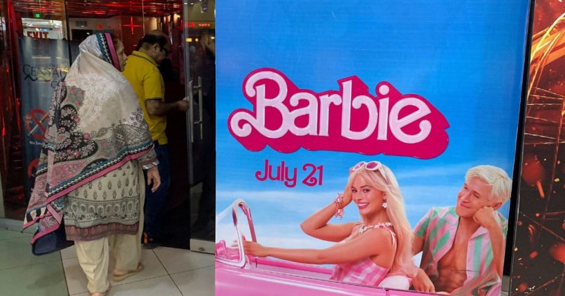 Moviegoers walk past the poster of the movie "Barbie" at a cineplex in Islamabad on Friday.