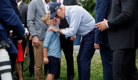 President Joe Biden talks with children during the Congressional Picnic on the South Lawn of the White House on July 12, 2022, in Washington, D.C.