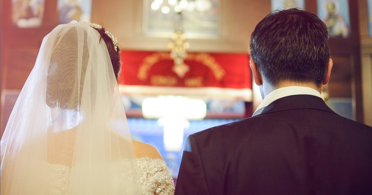 A bride and groom pictured from behind.