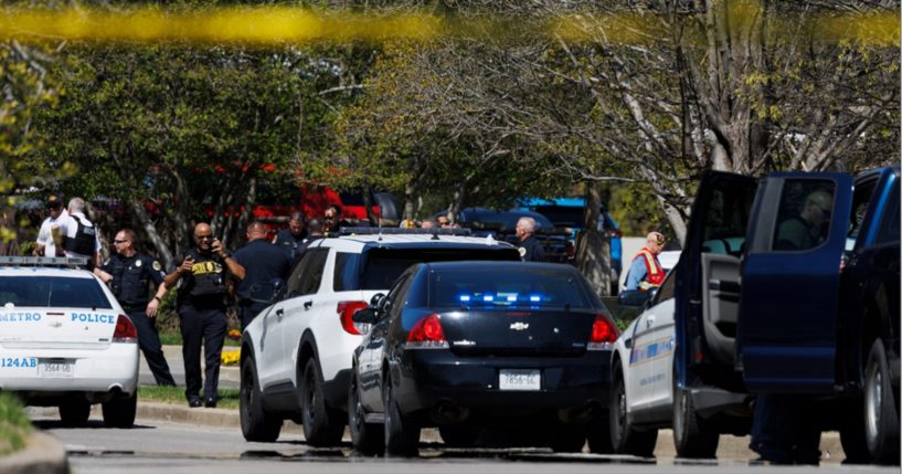 Police and emergency workers gather outside The Covenant School during the mass shooting at the Christian school in Nashville on March 27.