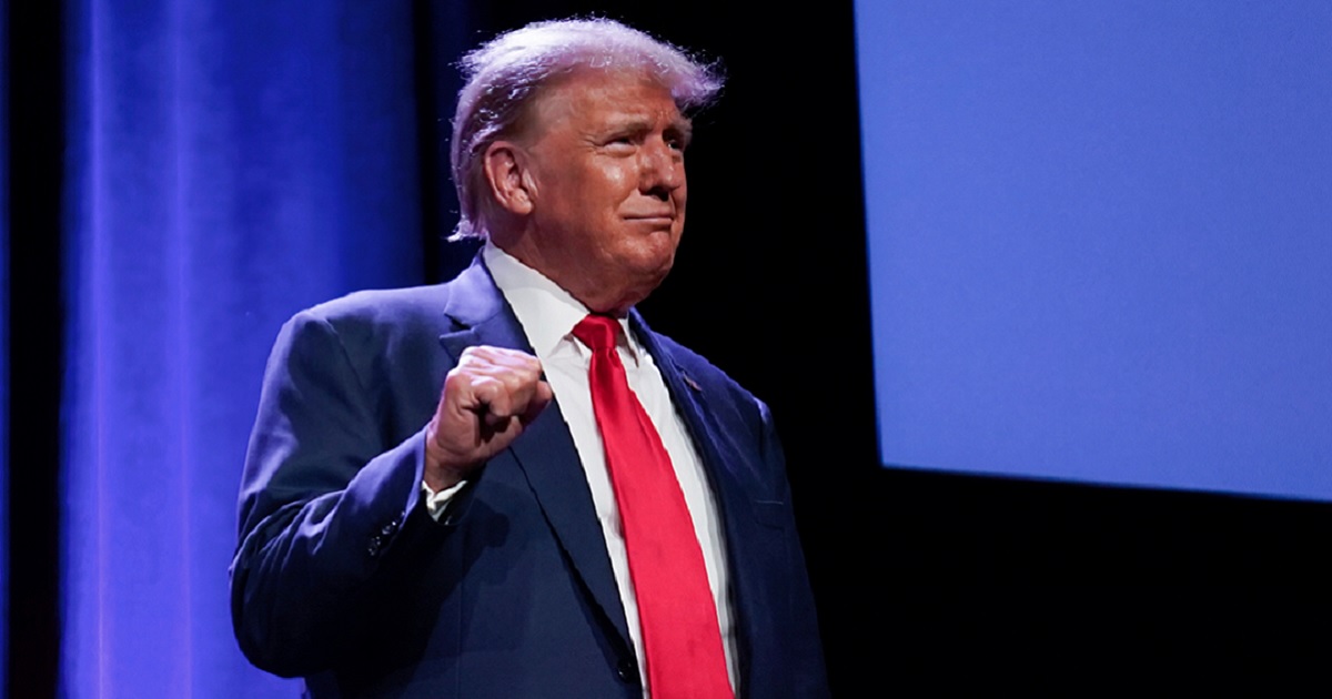 Former President Donald Trump greets the audience Friday during the Lincoln Day Dinner in Des Moines, Iowa.