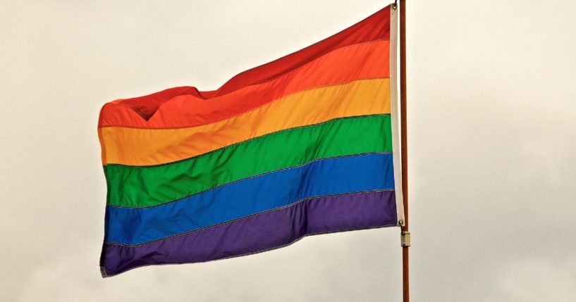 An LGBT flag flies in this stock image.