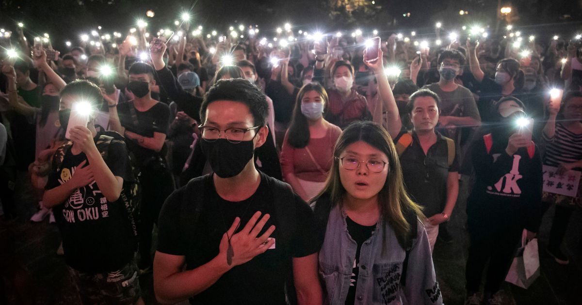 Demonstrators hold their cellphones aloft as they sing "Glory to Hong Kong" during a rally at Chater Garden in Hong Kong on Oct. 26, 2019.