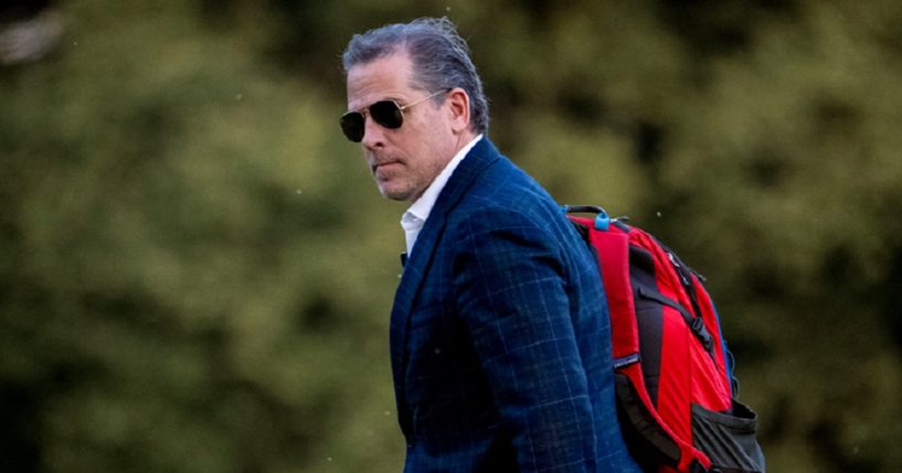 Hunter Biden carrying an overnight bag on his shoulder.