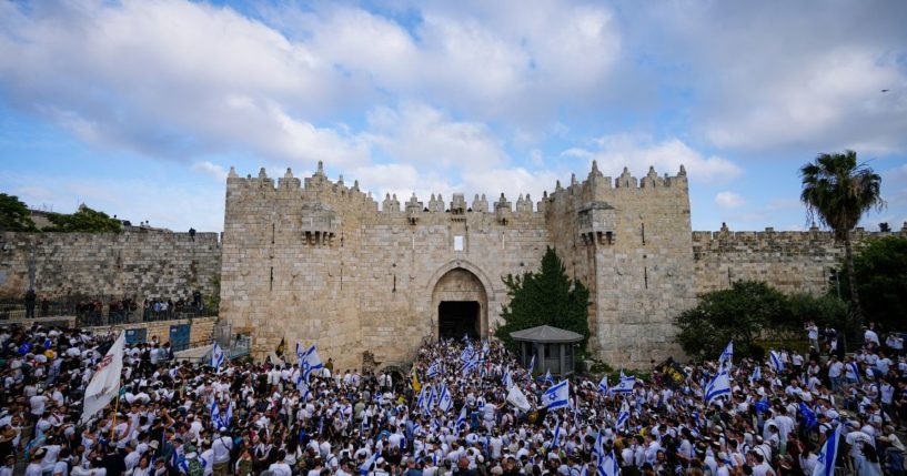 Israelis dance and wave national flags during a march marking Jerusalem Day, an Israeli holiday celebrating the capture of east Jerusalem in the 1967 Mideast War, in front of the Damascus Gate of Jerusalem's Old City on May 18.