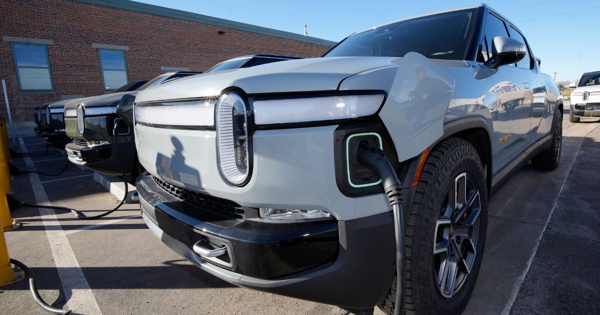 A 2023 R1T pickup truck is charged in a bay at a Rivian delivery and service center on February 8, in Denver, Colorado.