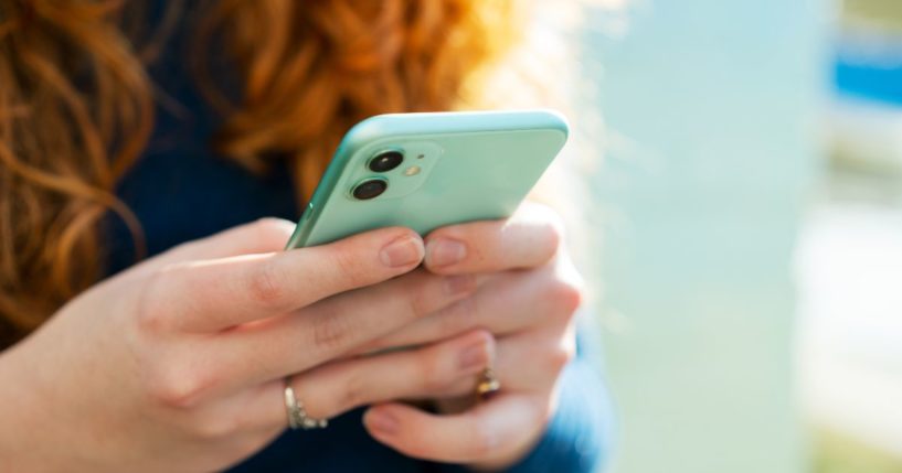 A woman is pictured using a smartphone. More and more smartphone apps marketed for mental health are actually pushing woke ideology.