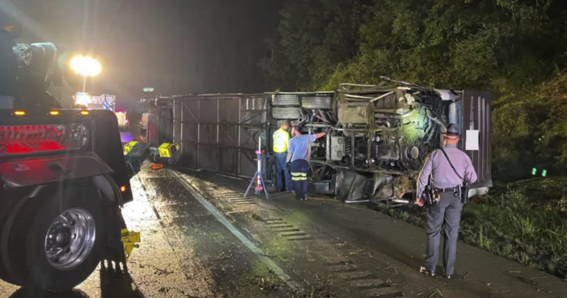 Police and rescue workers arrive on the scene of a bus crash late Sunday in Lower Paxton Township, Pennsylvania.