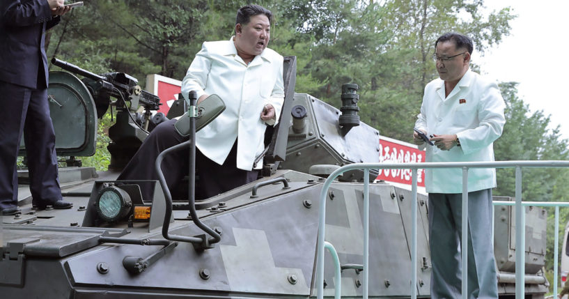 In this undated photo provided on Monday by the North Korean government, North Korean leader Kim Jong Un, center, rides on an armored vehicle during his visit to a military factory in North Korea last week. Independent journalists were not given access to cover the event depicted in this image, and its contents cannot be independently verified.