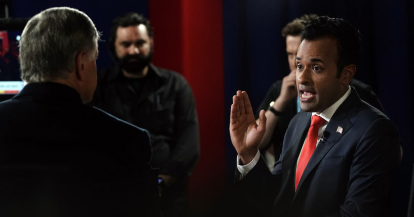 Businessman Vivek Ramaswamy talks with Fox News host Sean Hannity in the spin room after the Republican presidential primary debate in Milwaukee on Wednesday night.