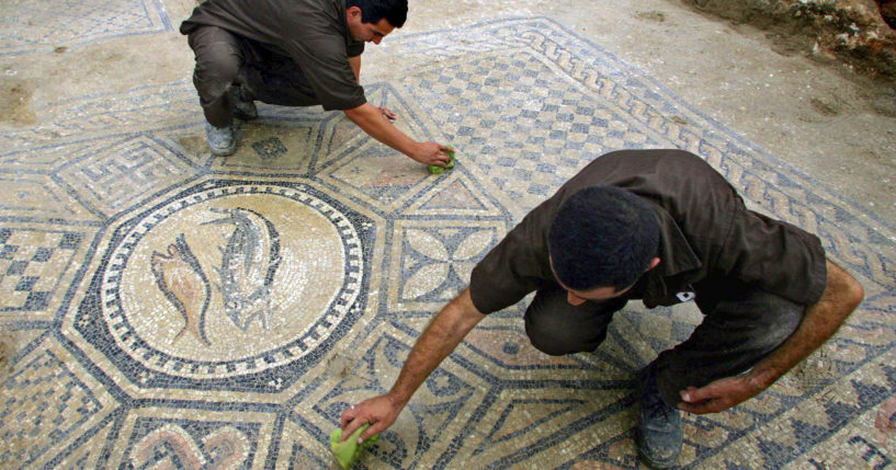 Prisoners work on a nearly 1,800-year-old decorated floor from an early Christian prayer hall discovered by Israeli archaeologists in the Megiddo prison on on Nov. 6, 2005.