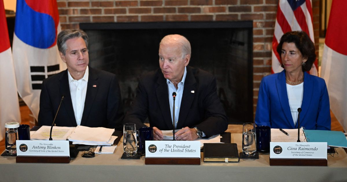 President Joe Biden. center, flanked by Secretary of State Antony Blinken, left, and Secretary of Commerce Gina Raimondo, speaks during a trilateral summit with Japanese Prime Minister Fumio Kishida, and South Korean President Yoon Suk Yeol at Camp David, Maryland, on Friday.